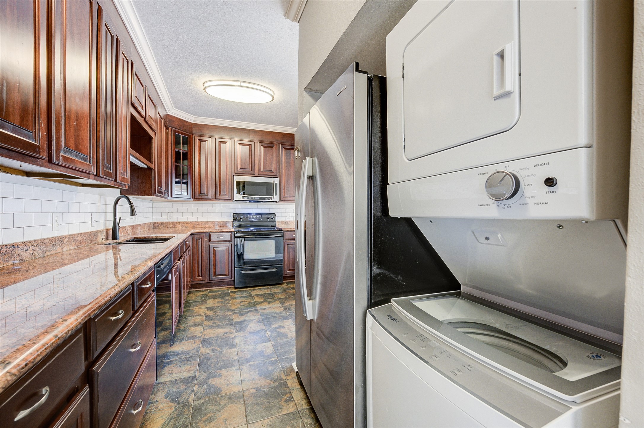2100 Tanglewilde Street, Unit 51 Houston, TX 77063 - Photo 11 of 24 a kitchen that has a sink and a stove