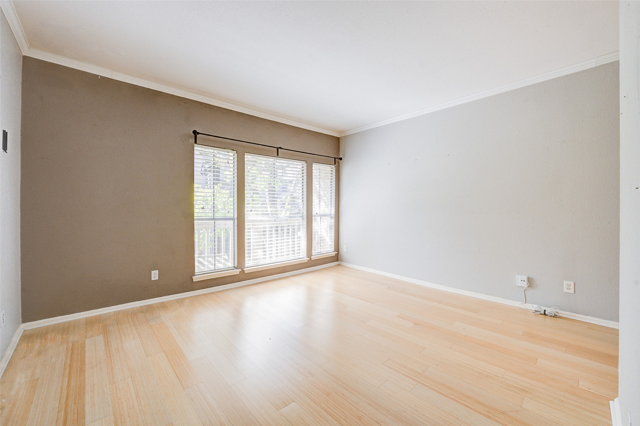 2100 Tanglewilde Street, Unit 51 Houston, TX 77063 - Photo 12 of 24 a view of an empty room with wooden floor and a window