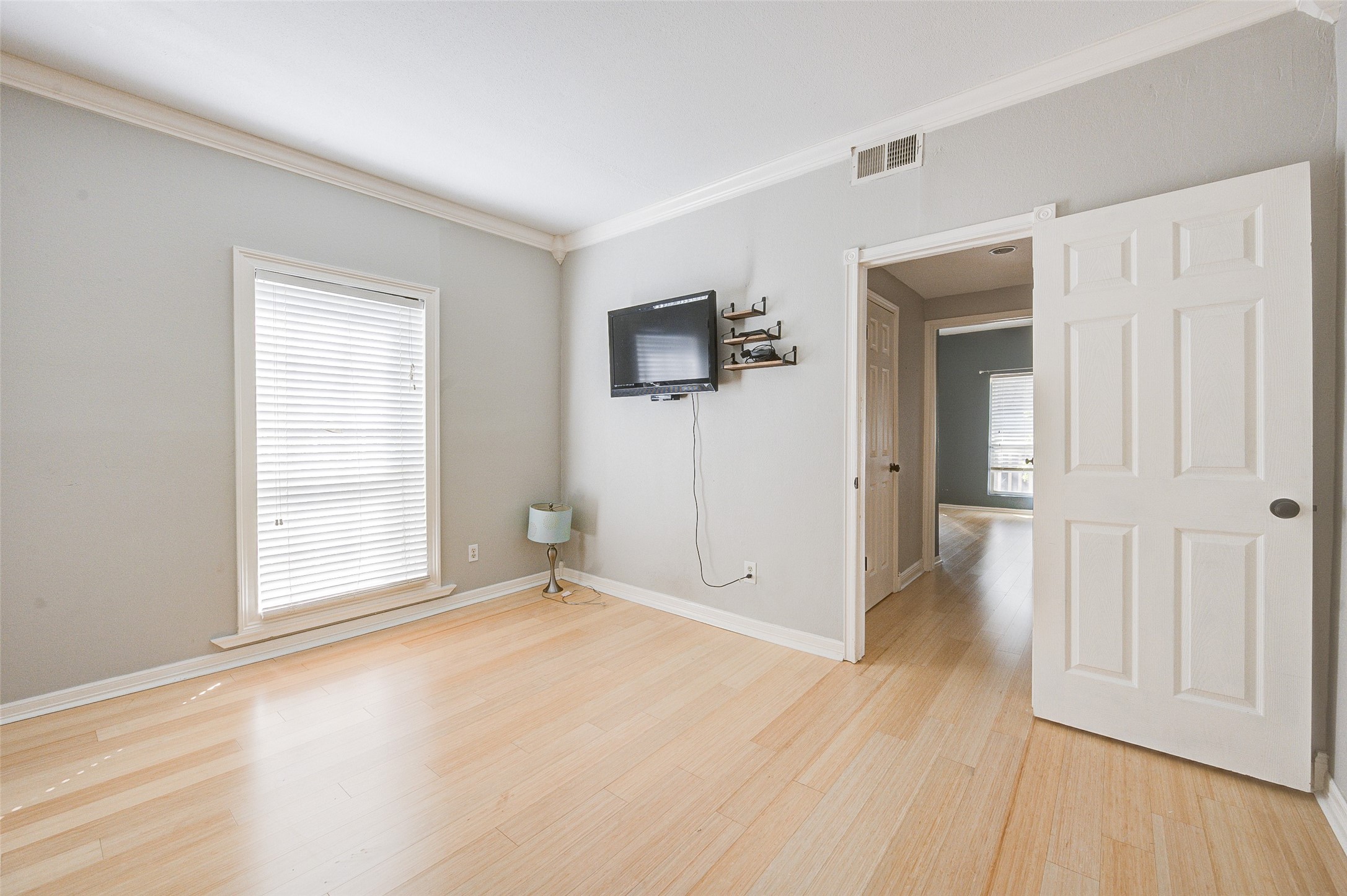 2100 Tanglewilde Street, Unit 51 Houston, TX 77063 - Photo 17 of 24 a view of an empty room with wooden floor and a window