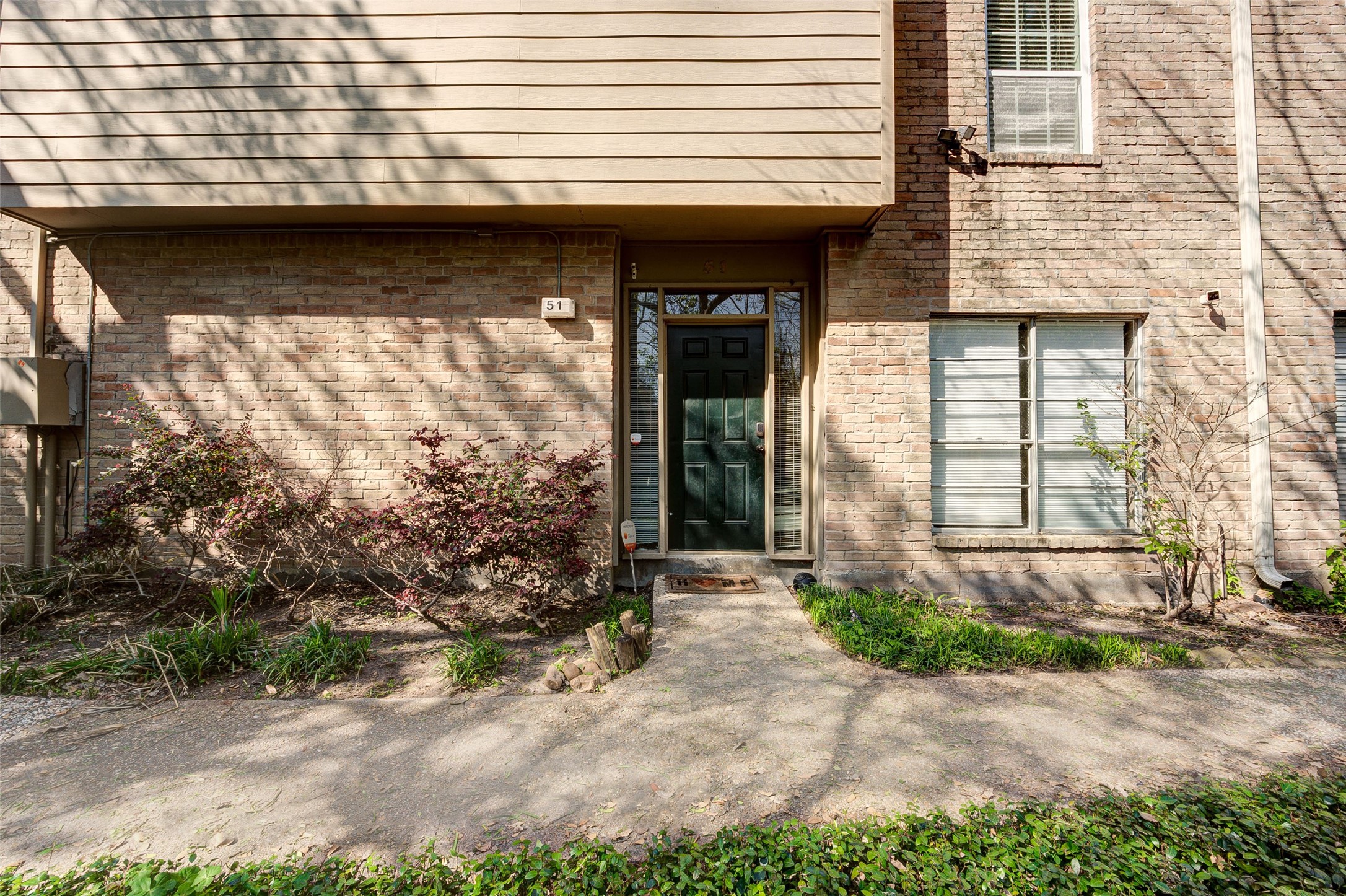 2100 Tanglewilde Street, Unit 51 Houston, TX 77063 - Photo 2 of 24 a front view of a house with garden