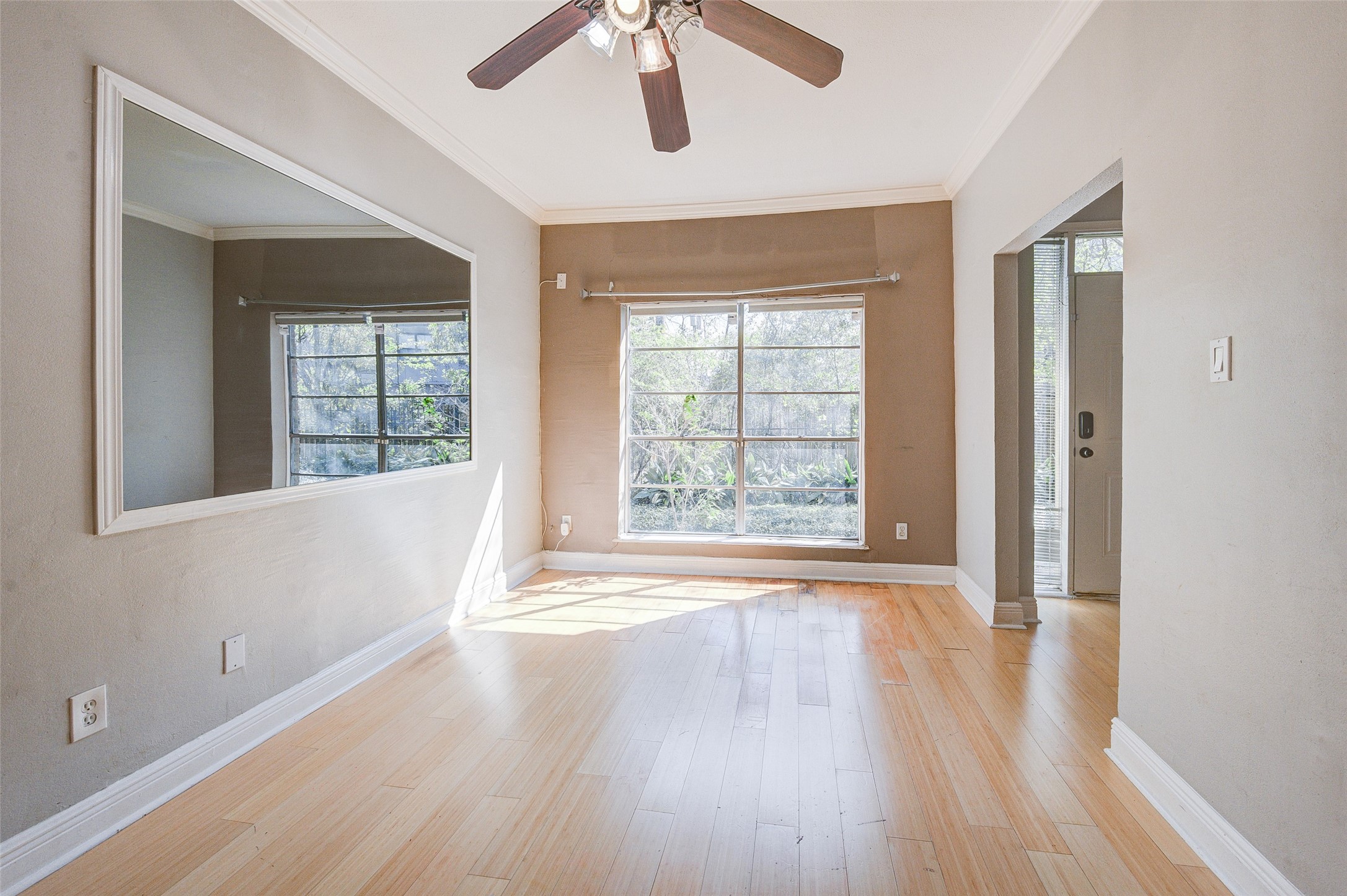 2100 Tanglewilde Street, Unit 51 Houston, TX 77063 - Photo 4 of 24 a view of an empty room with wooden floor and a window