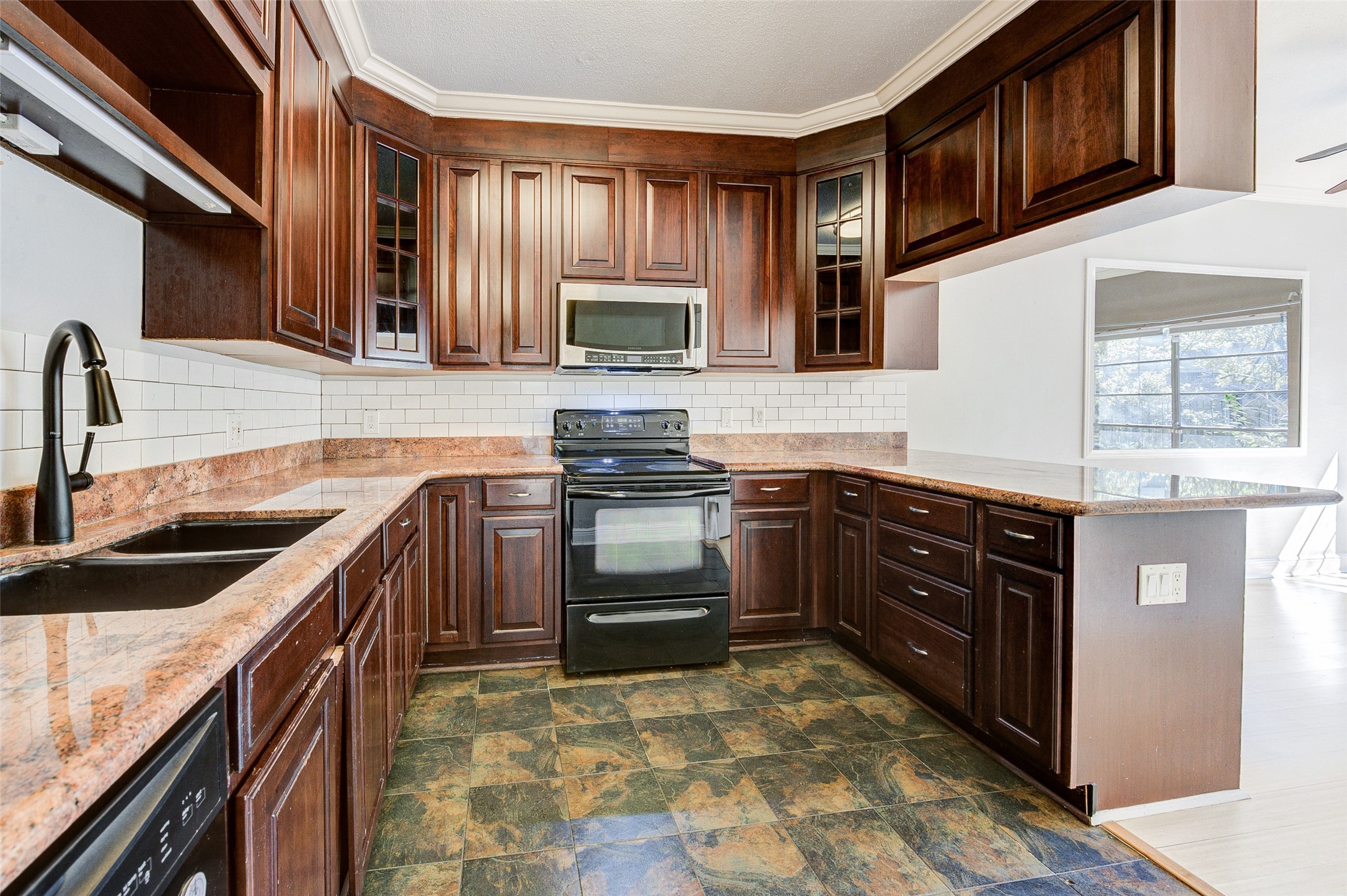 2100 Tanglewilde Street, Unit 51 Houston, TX 77063 - Photo 10 of 24 a kitchen with stainless steel appliances granite countertop a sink stove and cabinets
