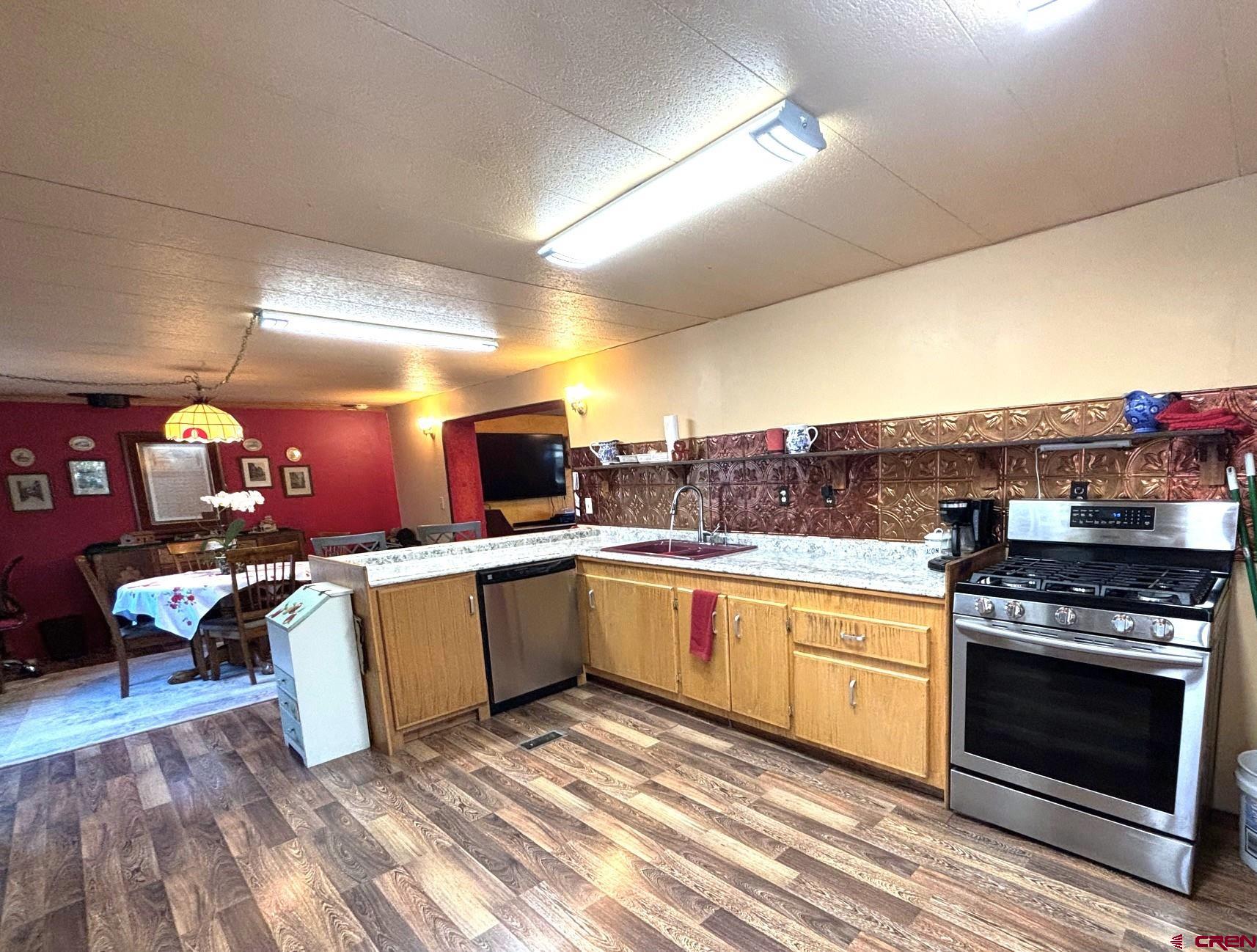 135 Aspenglow Lane Ridgway, CO 81432 - Photo 6 of 19 a kitchen with stainless steel appliances granite countertop a stove and cabinets