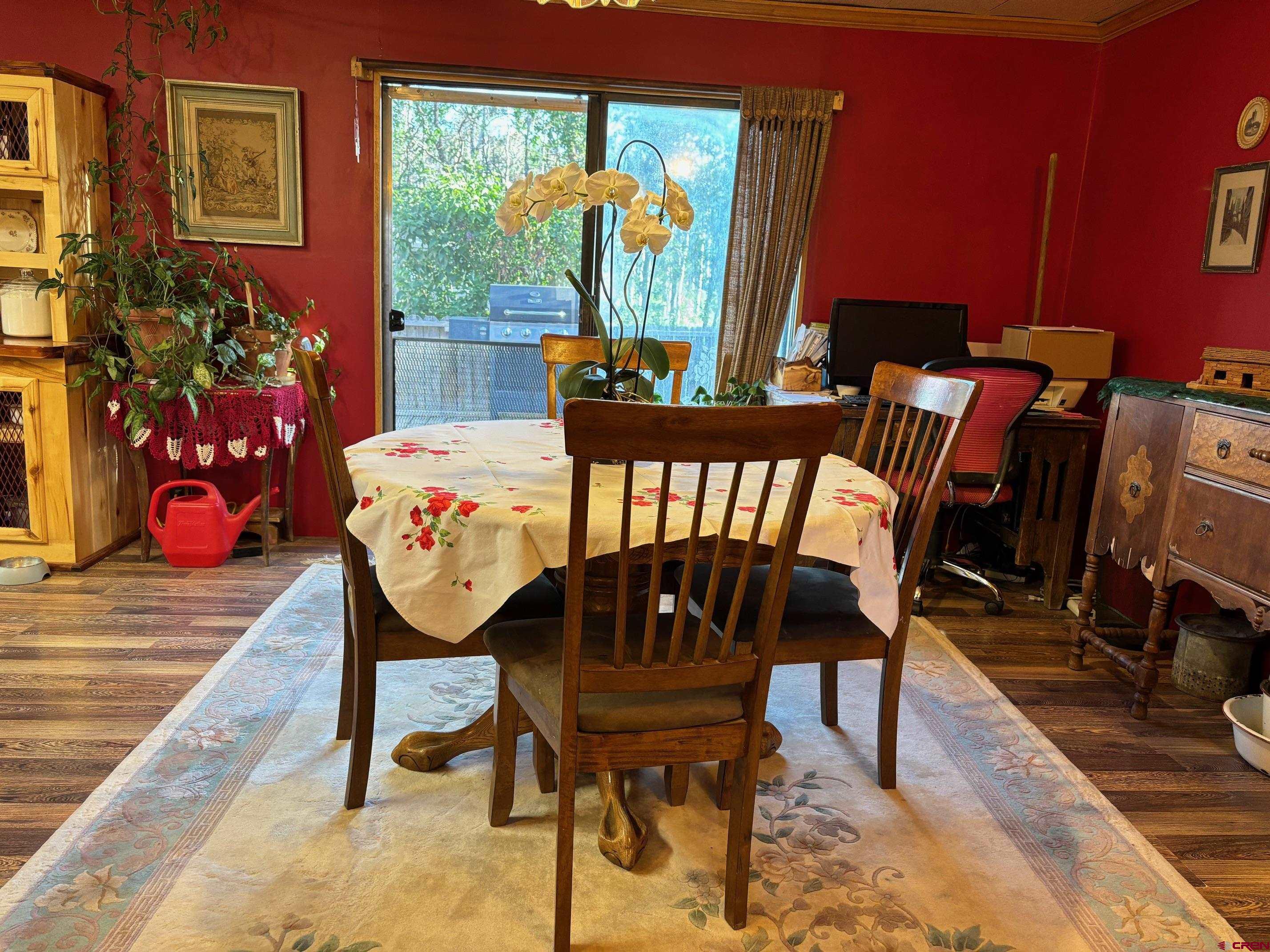 135 Aspenglow Lane Ridgway, CO 81432 - Photo 7 of 19 a view of a dining room with furniture window and wooden floor