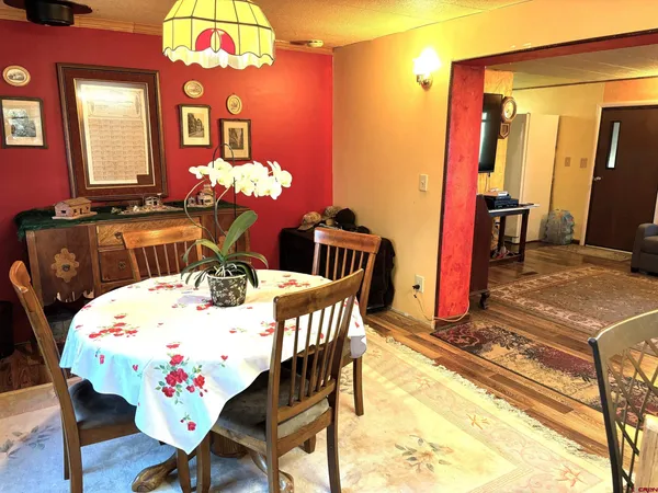 a view of a dining room with furniture and chandelier
