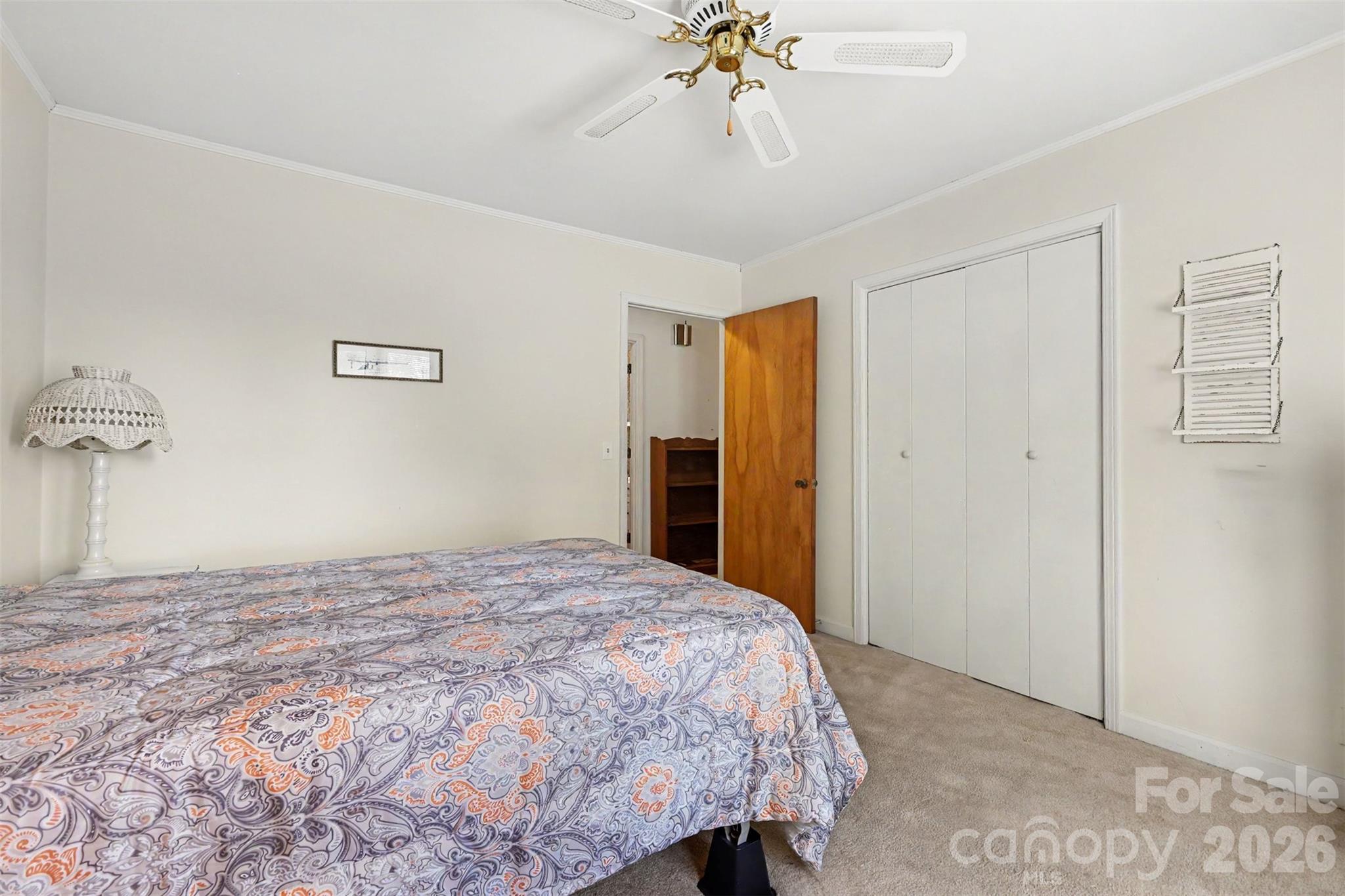 6774 Woodhaven Road Kershaw, SC 29067 - Photo 25 of 30 a bedroom with a bed and a chandelier