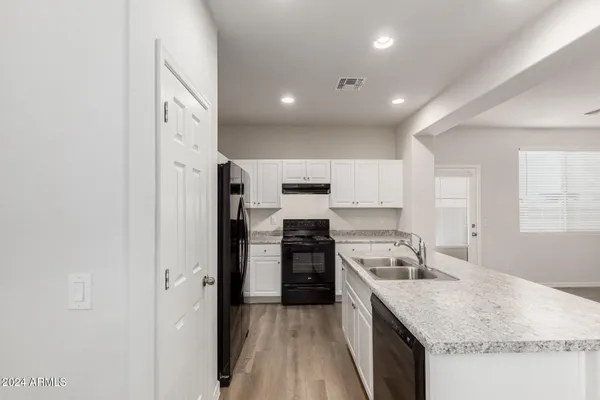 a kitchen with a sink stove and refrigerator