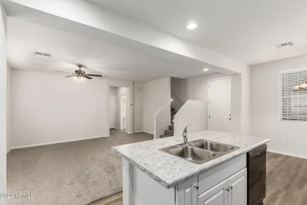 a kitchen with a sink a stove and cabinets