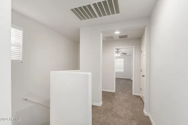 a view of a hallway with white walls