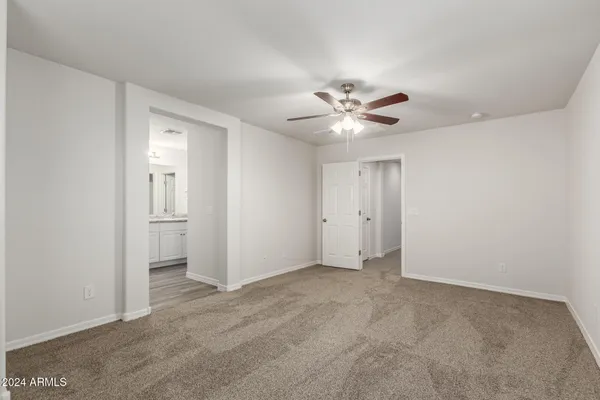 a view of an empty room with a ceiling fan