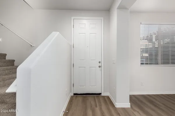a view of a room with wooden floor and a window