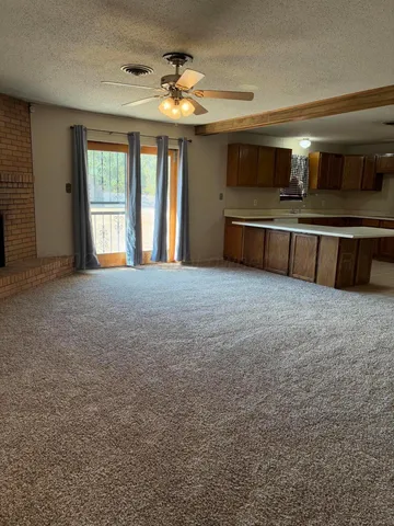 a big room with windows and a kitchen