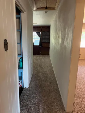 a view of hallway with wooden floor