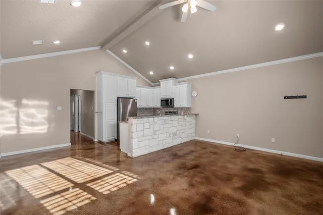 a view of a backyard with a garden and entertaining space