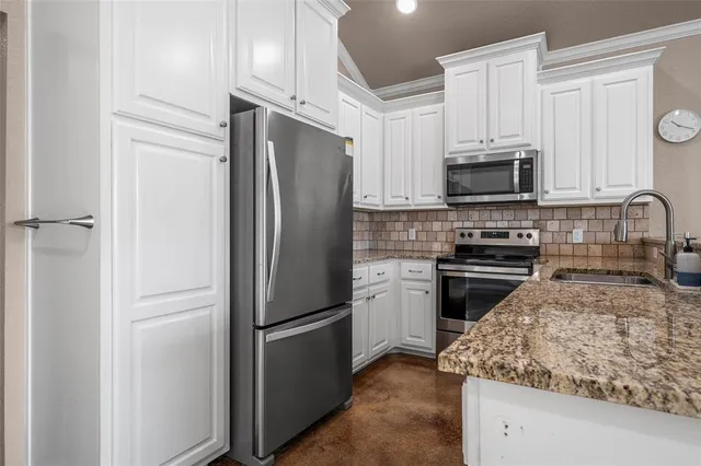 a kitchen with a refrigerator stove and microwave