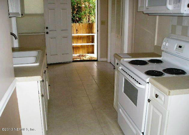 5039 Sunderland Road Jacksonville, FL 32210 - Photo 1 of 20 a kitchen with a stove and a refrigerator