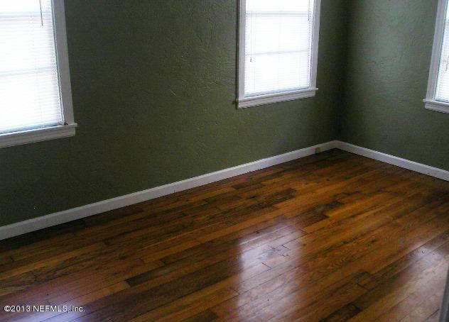 5039 Sunderland Road Jacksonville, FL 32210 - Photo 13 of 20 a view of a room with wooden floor and windows