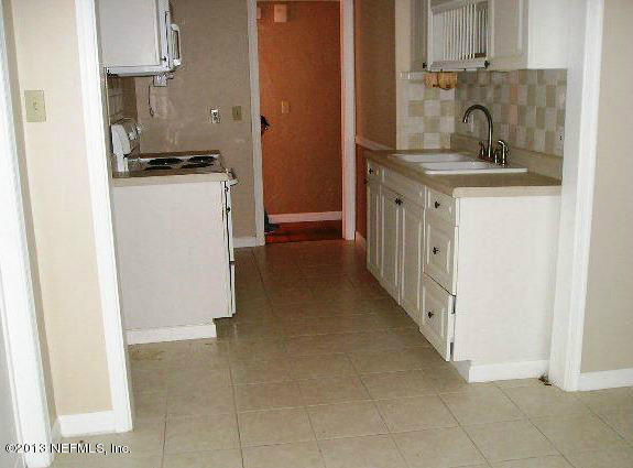 5039 Sunderland Road Jacksonville, FL 32210 - Photo 15 of 20 a kitchen with stainless steel appliances granite countertop a sink stove and refrigerator