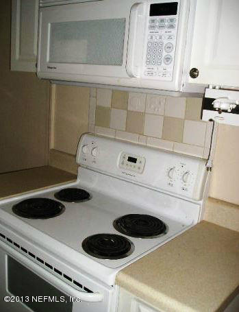5039 Sunderland Road Jacksonville, FL 32210 - Photo 16 of 20 a kitchen with a stove and a microwave
