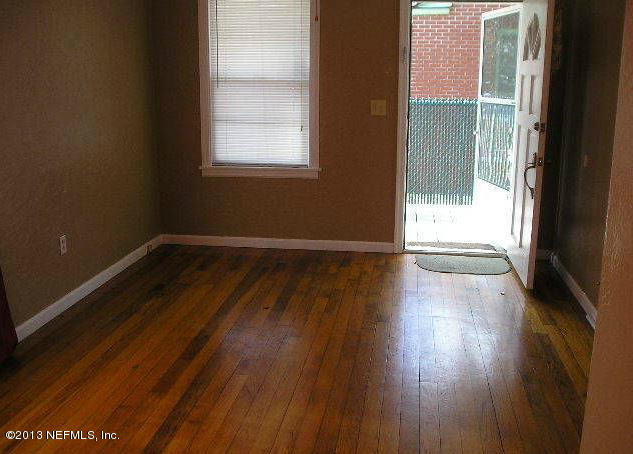 5039 Sunderland Road Jacksonville, FL 32210 - Photo 17 of 20 an empty room with wooden floor and windows