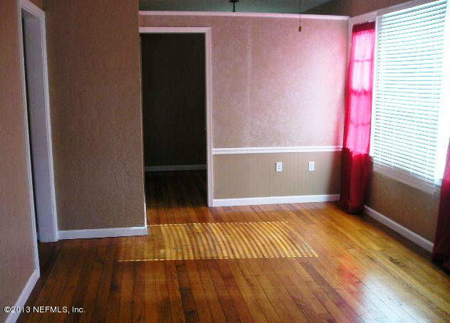 5039 Sunderland Road Jacksonville, FL 32210 - Photo 18 of 20 a view of an empty room with wooden floor and a window