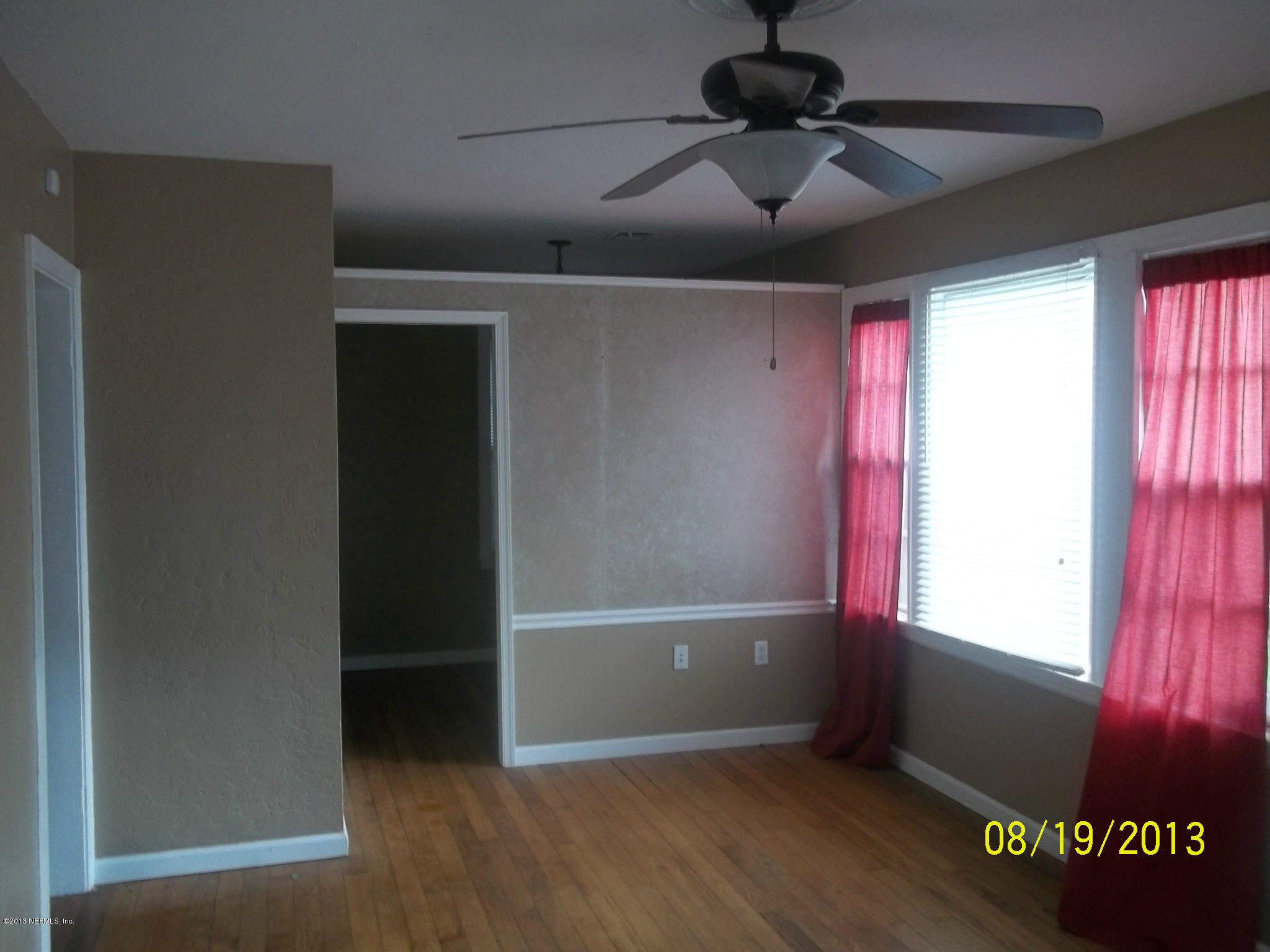 5039 Sunderland Road Jacksonville, FL 32210 - Photo 2 of 20 an empty room with windows and fan
