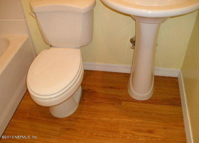 5039 Sunderland Road Jacksonville, FL 32210 - Photo 9 of 20 a bathroom with a toilet and a mirror