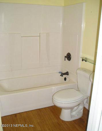 5039 Sunderland Road Jacksonville, FL 32210 - Photo 10 of 20 a white toilet sitting next to a shower