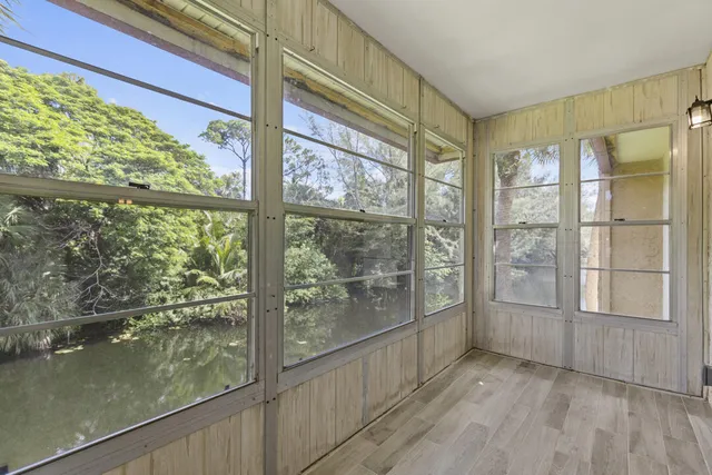 a view of a room with wooden floor and windows