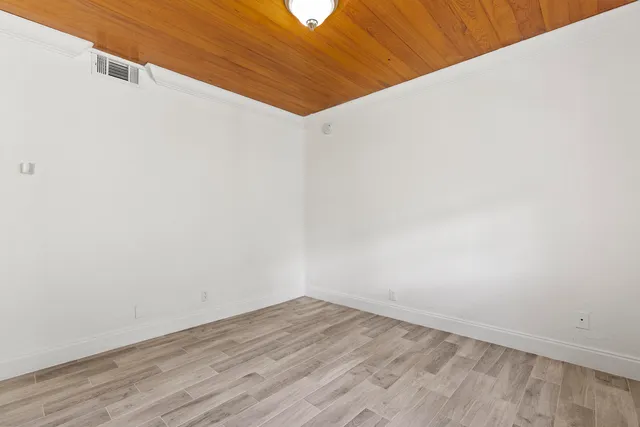 a view of a room with wooden floor
