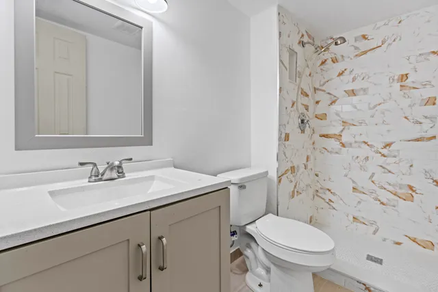 a bathroom with a sink toilet and shower