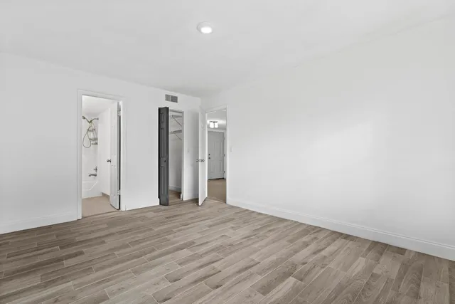 a view of a room with wooden floor