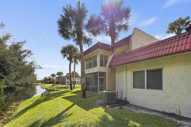 a view of house with yard outdoor seating and barbeque oven