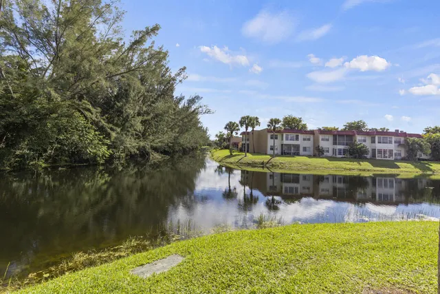 a view of swimming pool with a yard and a fountain