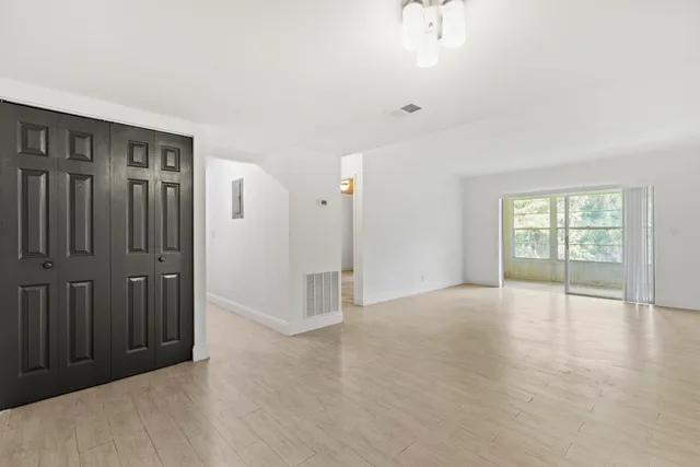 wooden floor in an empty room with a window