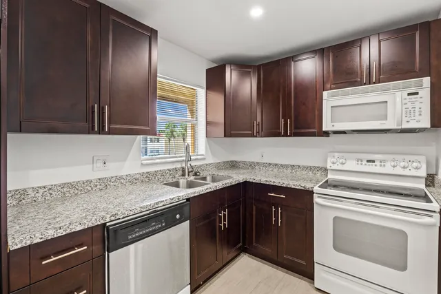 a kitchen with a sink stove and cabinets