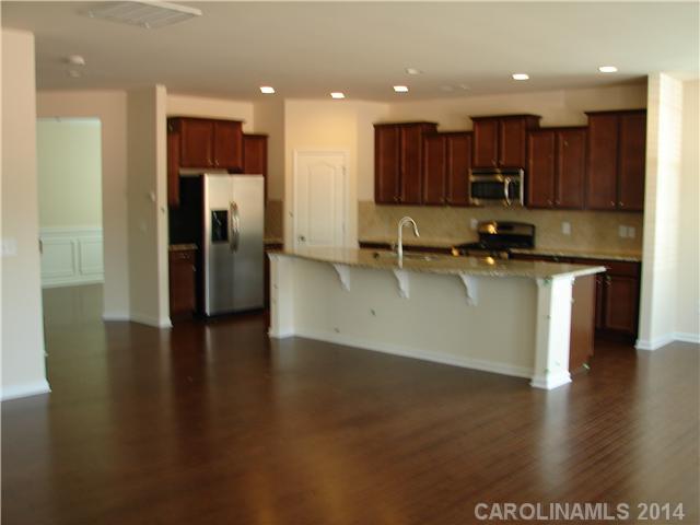 4113 Perth Road, Unit 375 Indian Land, SC 29707 - Photo 9 of 9 a kitchen with stainless steel appliances granite countertop a refrigerator a sink and a stove