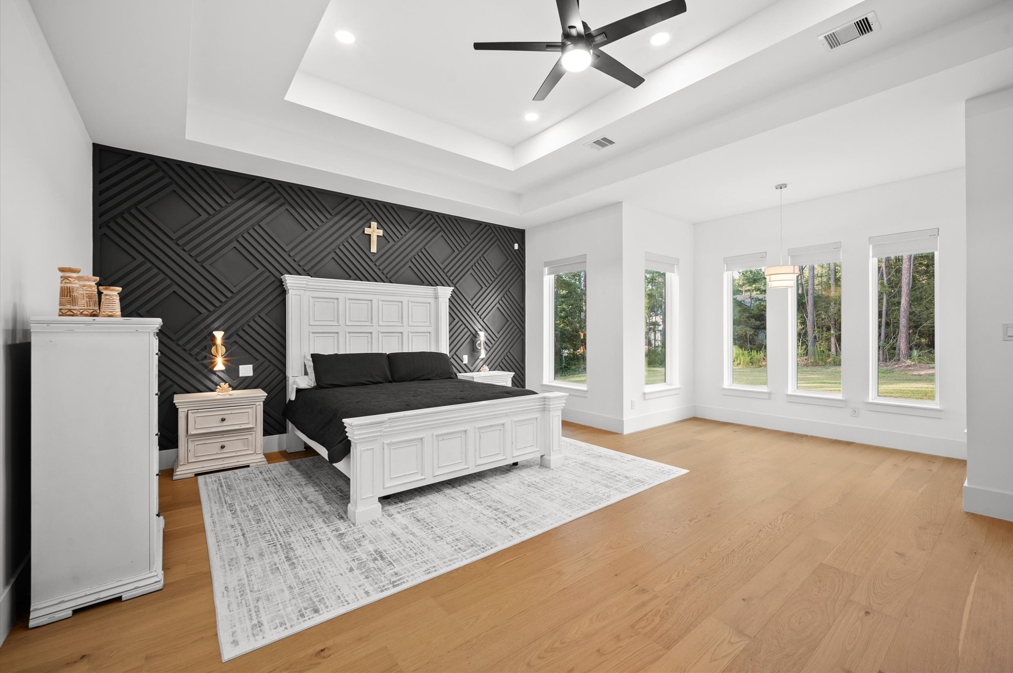 437 Sundog Road Huntsville, TX 77340 - Photo 25 of 50 Oversized primary suite with peaceful backyard views. Large windows fill the room with natural light.
