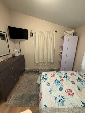 a bedroom with a bed and a mirror