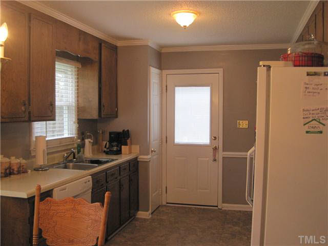 405 Wilson Jones Road Clayton, NC 27520 - Photo 12 of 16 Stainless steel sink/new flooring/chair rail/crown molding.