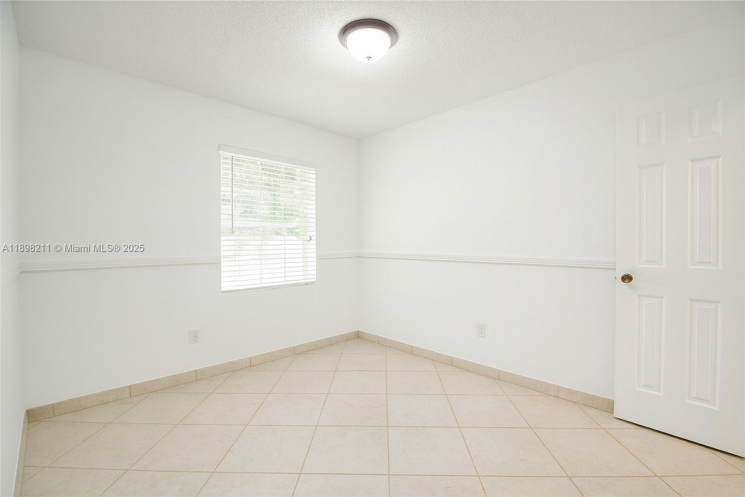 14478 Southwest 139th Ave Circle West, Unit 14478 Miami, FL 33186 - Photo 11 of 25 an empty room with a empty space and a window