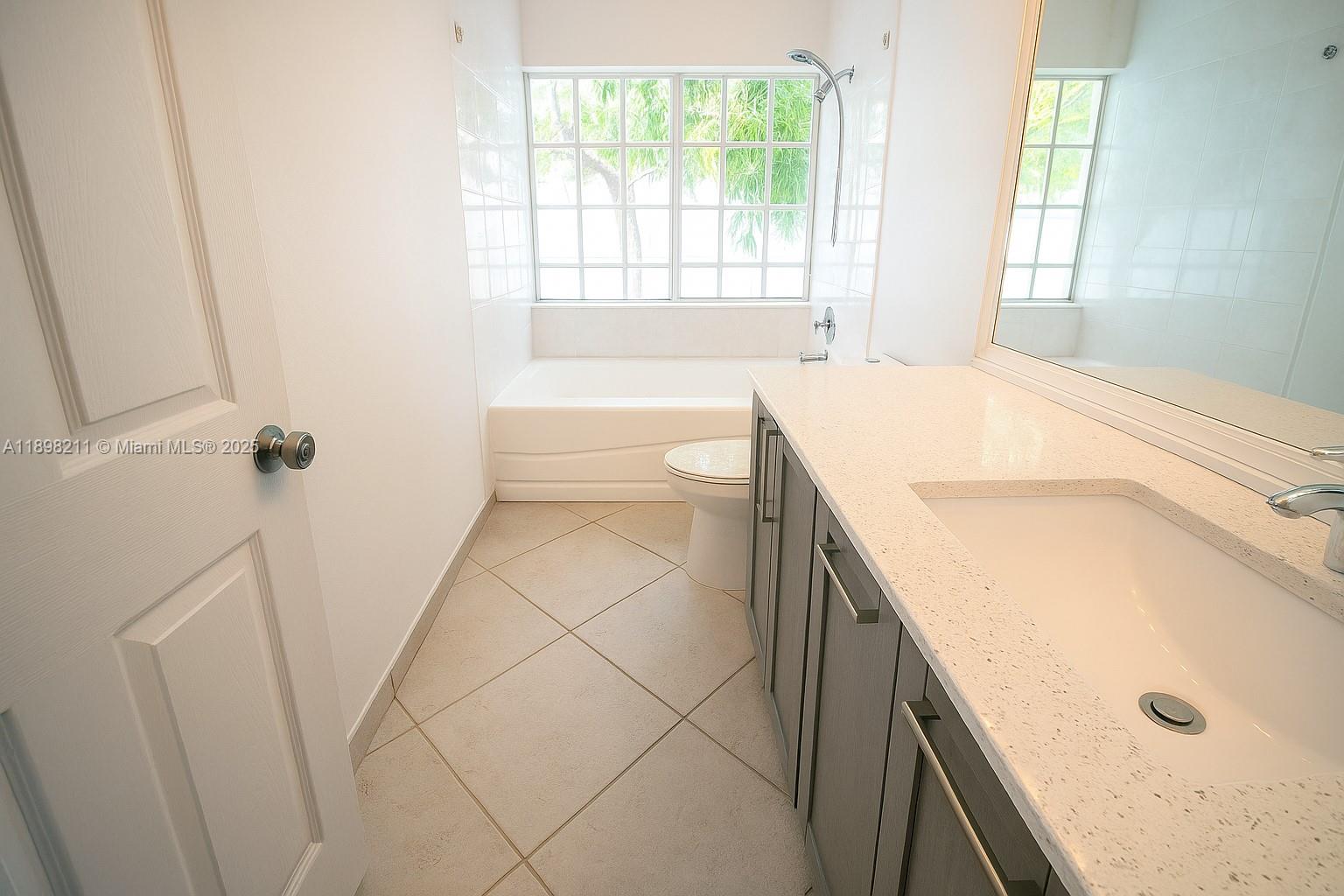 14478 Southwest 139th Ave Circle West, Unit 14478 Miami, FL 33186 - Photo 13 of 25 a bathroom with a tub sink and a shower