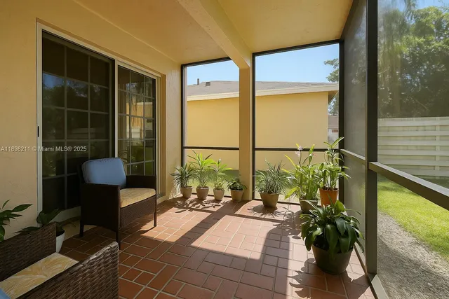 a living room filled with furniture and a potted plant