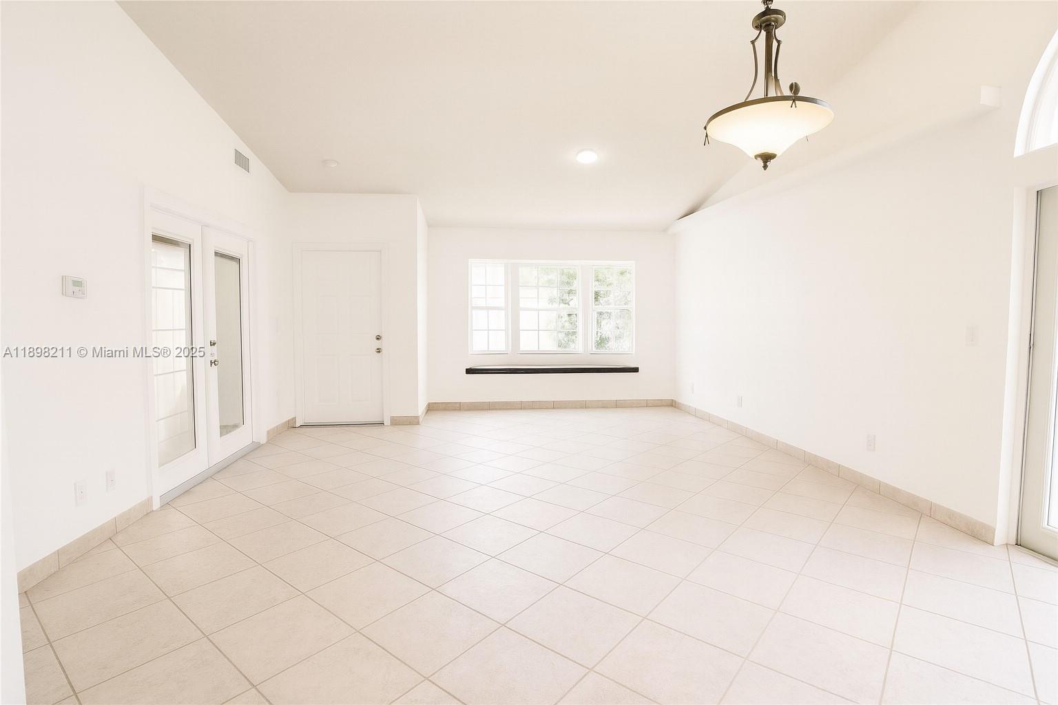 14478 Southwest 139th Ave Circle West, Unit 14478 Miami, FL 33186 - Photo 4 of 25 a view of an empty room with a window