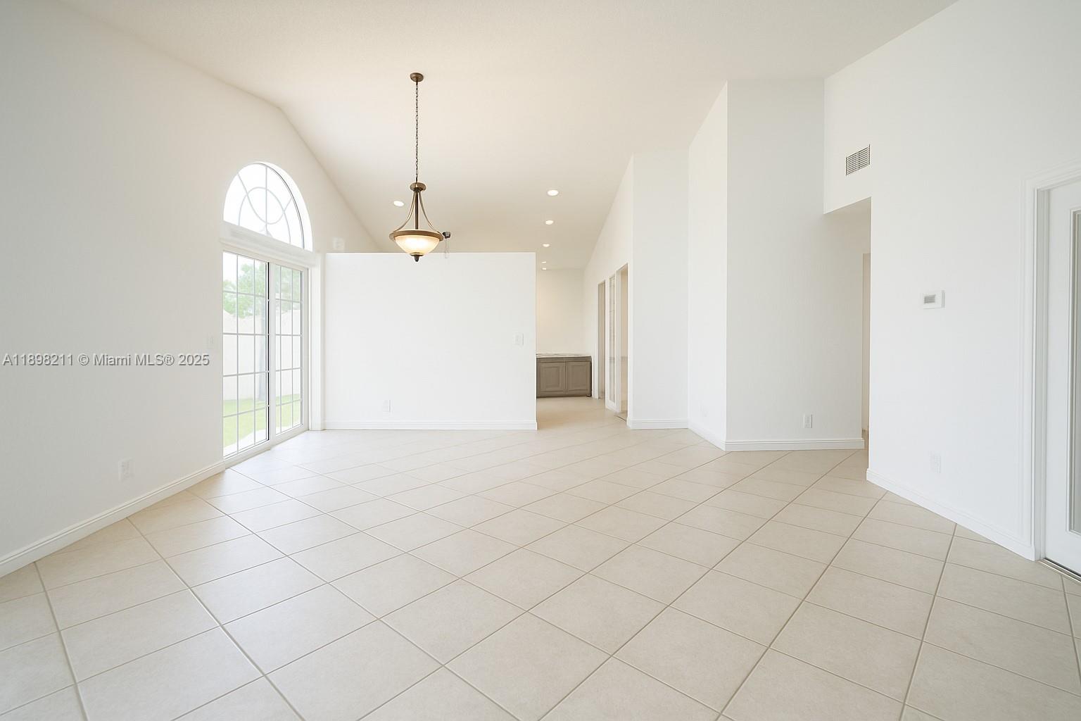 14478 Southwest 139th Ave Circle West, Unit 14478 Miami, FL 33186 - Photo 6 of 25 a view of a room with wooden floor and windows