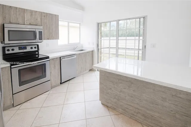 a kitchen with a stove a sink and a microwave