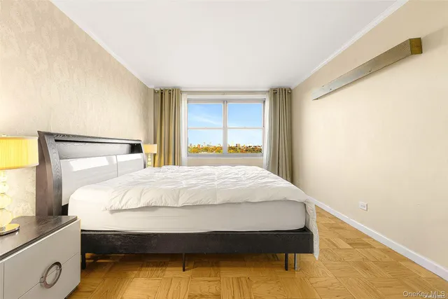 a bed sitting in a bedroom next to a window