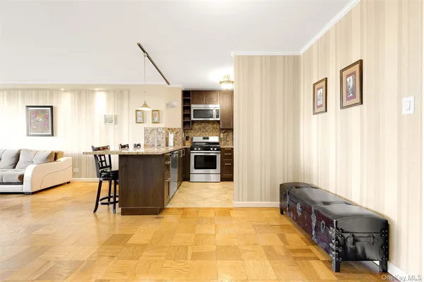 a living room with stainless steel appliances kitchen island granite countertop furniture and a kitchen view