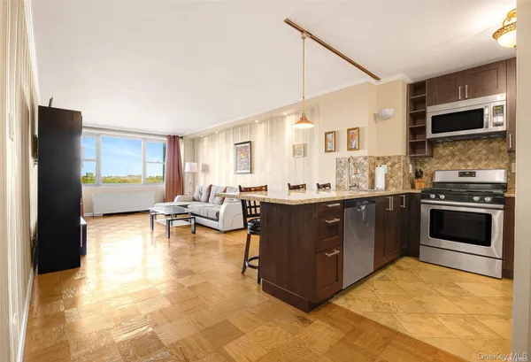 a kitchen with stainless steel appliances granite countertop a stove a sink and a refrigerator