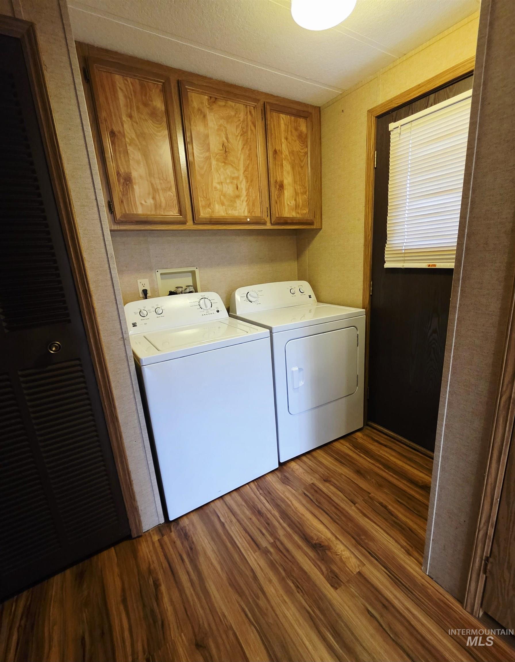 2015 6th Avenue, Unit 14 Clarkston, WA 99403 - Photo 13 of 27 Washroom with cabinet space, dark wood finished floors, and washer and dryer